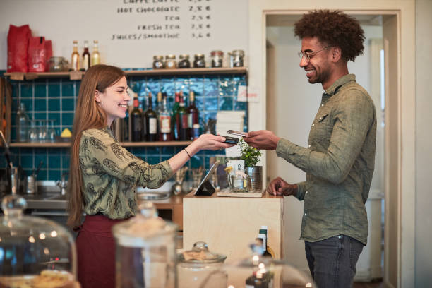 istock Contactless paying in a small business. 1147963300