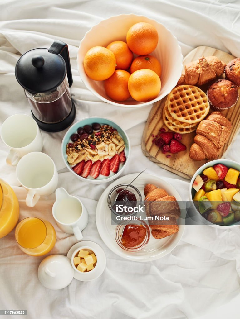 Good mornings are made with good breakfast High angle shot of a delicious breakfast spread on a bed at home Breakfast Stock Photo