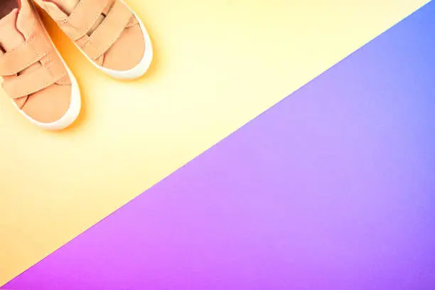 Photo of Sneakers on a trendy neon color background, top view, summer shoes.