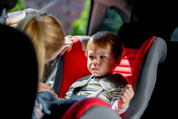 istock Baby boy being fastened in car seat 1147965438