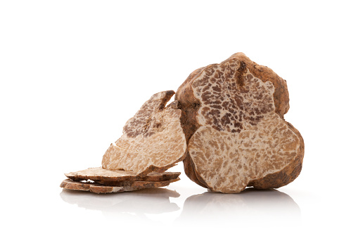 White truffle cross section and slices isolated on white background.