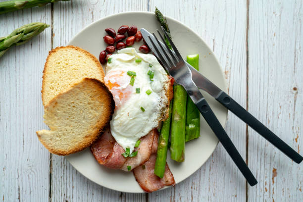 istock homemade easy breakfast: fried egg, asparagus and bacon 1147967527