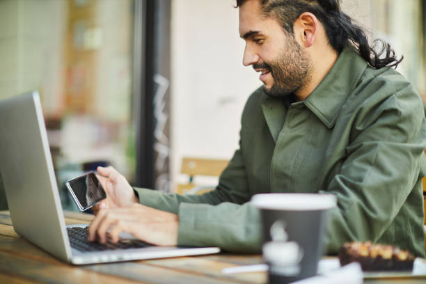 istock Young man looking at his finances in a mobile phone. 1147967887