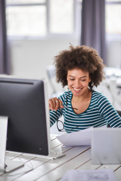 istock Businesswoman doing paperwork in modern office 1147970307