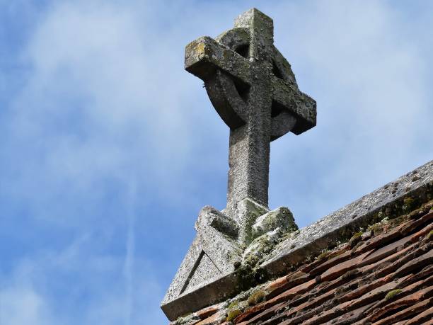 istock Stone cross on church rooftop 1147970368