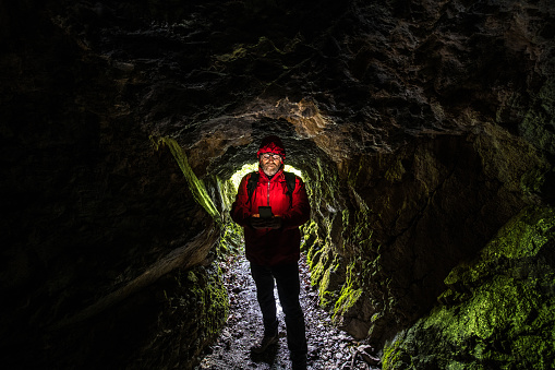 Man exploring caves in Julian Alps mountains, Slovenia, Europe.