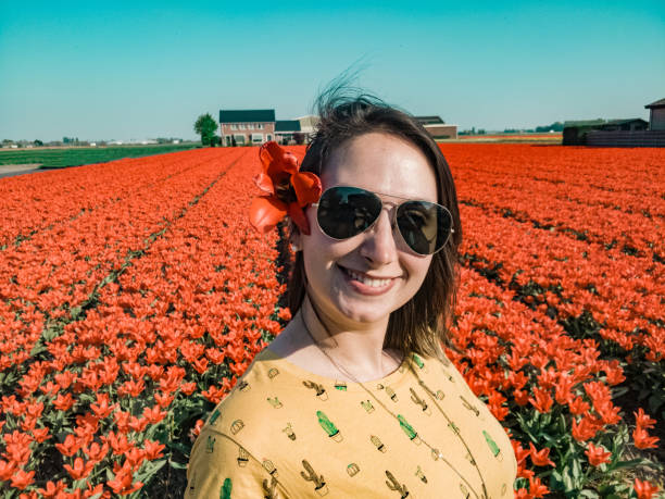 istock Woman with flower, fields in the Netherlands 1147971230