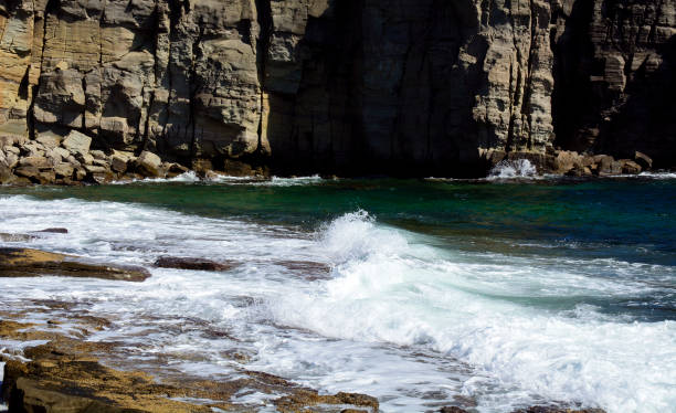istock sea waves crashing against rocks 1147973606