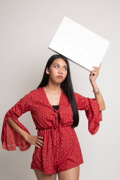 istock Young Asian woman with white blank sign. 1147973886