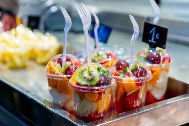 Plastic Cups With Delicious Fruits For Sale Stock Photo - Download