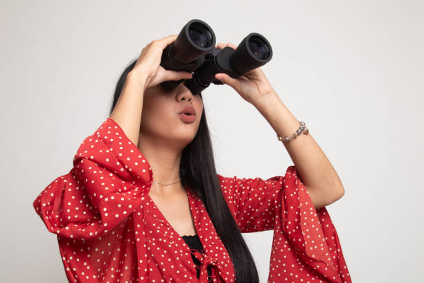 istock Young Asian woman with binoculars. 1147974930