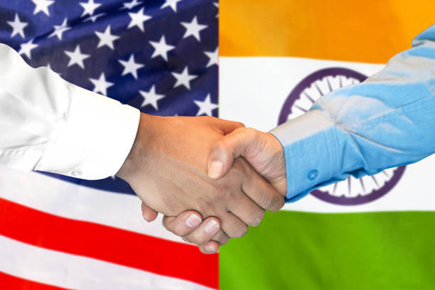 istock handshake on India and USA flag background. 1147975342