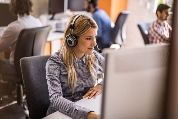 istock Female customer service representative working on desktop PC in the office. 1147976572