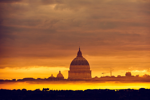 St. Peter's Basilica In Vatican in sunset time, dramatic sky.