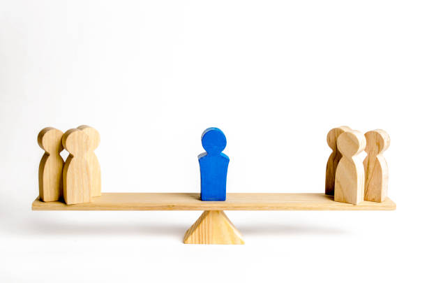 istock The leader stands on the scales between two groups of people. Resolving conflict situations. The union of two opposing groups of people. Conflict of interest. Leadership, choice side. 1147976865