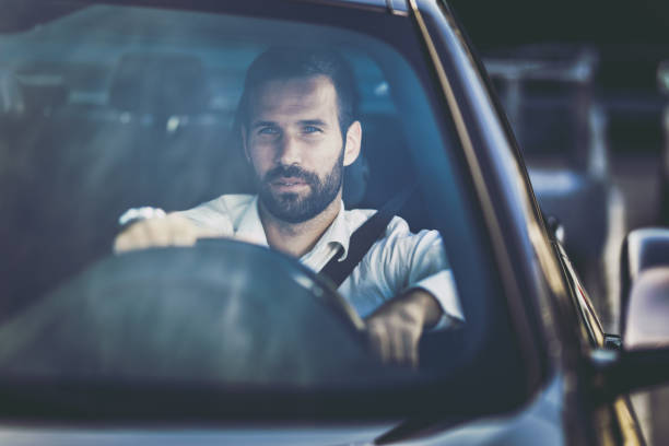 istock Young pensive businessman driving a car. 1147978236