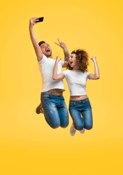 istock Couple jumping and taking selfie 1147978438