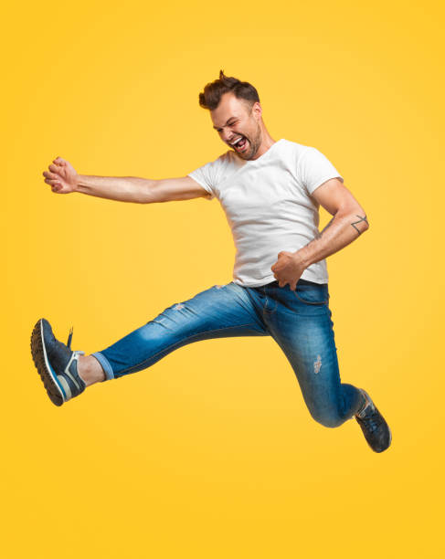 istock Man jumping and pretending to play guitar 1147978514