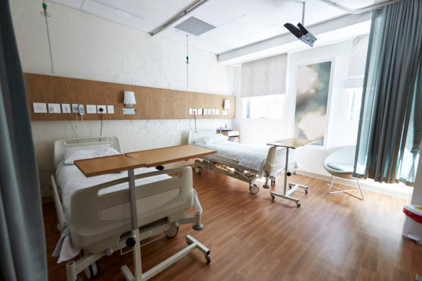 istock Beds In Empty Hospital Ward 1147978618