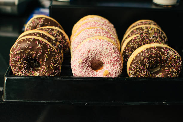 istock Variety of donuts on a tray in a display case 1147979691