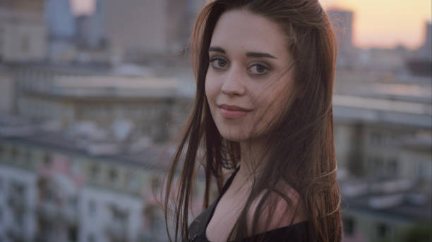 istock Seductive young woman posing on a rooftop 1147980053