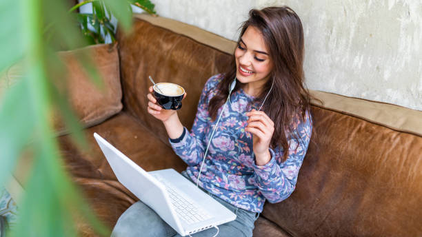 istock Woman working on laptop computer at a coffee shop. 1147981111