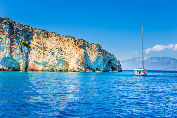 Bright blue sea water Great holiday in Greece. The fabulous island of Zakynthos. Sailing on a yacht along the picturesque island coast. Bright blue sea water reflects coastal cliffs. The concept of marine, active and resort recreation snow white and the seven dwarfs photos stock pictures, royalty-free photos & images