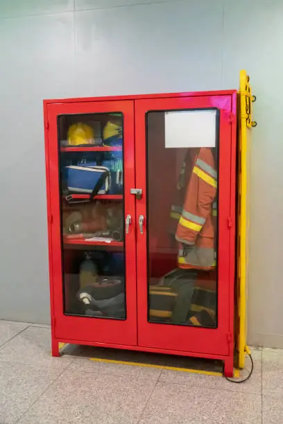 Photo of Rescue firefighter equipment, extinguisher, firemen suits, helmets, boots and fire line in red box.Fire fighting concept.