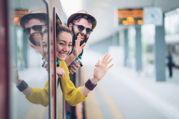 istock Young couple waving from the train window 1147985390