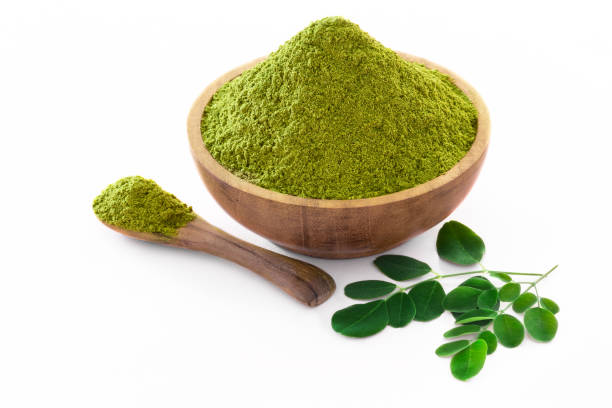 istock Moringa powder (Moringa Oleifera) in wooden bowl on white background with copyspace. 1147988131