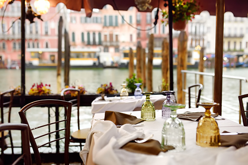 Stylish outdoor cafe in Venice. Sightseeng tour in Italy.
