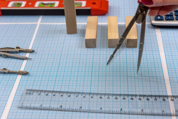 Compass with ruler on millimeter paper close up