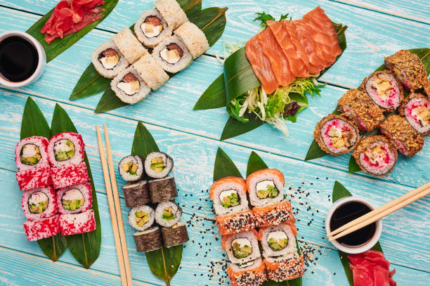 sushi roll set . sushi, sashimi, maki flat lay at blue wooden backdrop. japan cuisine. - sushi food vegetarian food japanese cuisine imagens e fotografias de stock