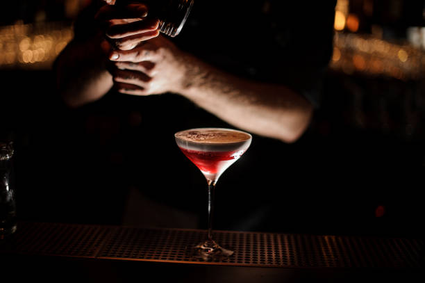 istock Bartender sprinkles an alcohol cocktail in glass 1147994793