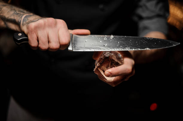 istock Close-up of bartender crushing ice with a knife 1147996205