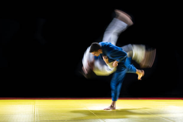 Cropped Image Of People Practicing Aikido In Dojo