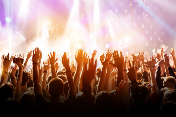 istock Crowd with raised hands on music concert 1147997273