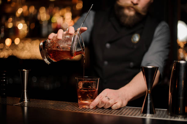 istock Close-up of male bartender pouring cocktail using strainer 1147997309