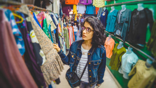 istock Young woman shops at garment shop. 1147997601