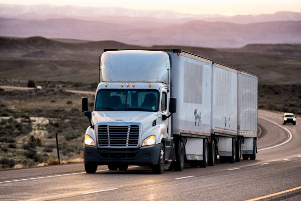 istock Long Haul Semi Truck on a Highway at Dusk under a Dramatic Sky 1147997623