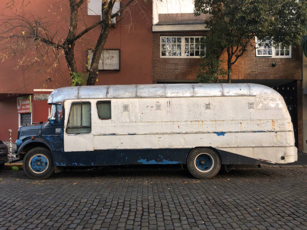 Vintage bus parked in the street Buenos Aires, Argentina - May 8, 2019:  Old Mercedes-Benz bus parked next to sidewalk in residential district. This type of old vehicle can still be seen moving around the city mercedes argentina stock pictures, royalty-free photos & images