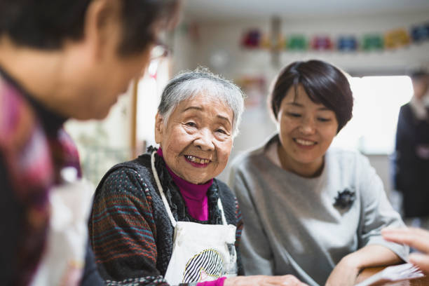 Community of Japanese females making handicraft products. Mature adults and senior people are working together.