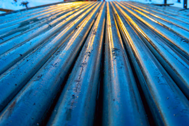 istock Pipe metal texture. Drillpipe on Oil Rig Pipe Deck. Rusty drill pipes were drilled in the well section. 1148001612