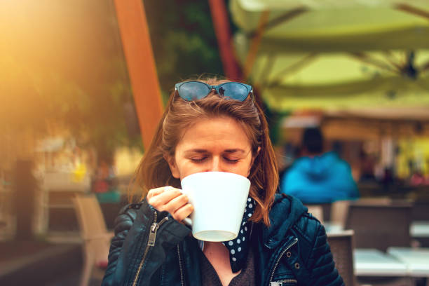 istock Woman drinking coffee or tea from a big mug 1148001951