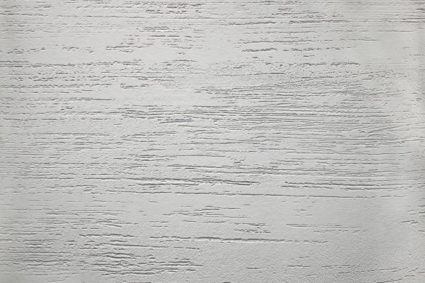 istock Light textured plaster on the wall with stripes. The texture on the wall is rough without seams cream decor. 1148002296