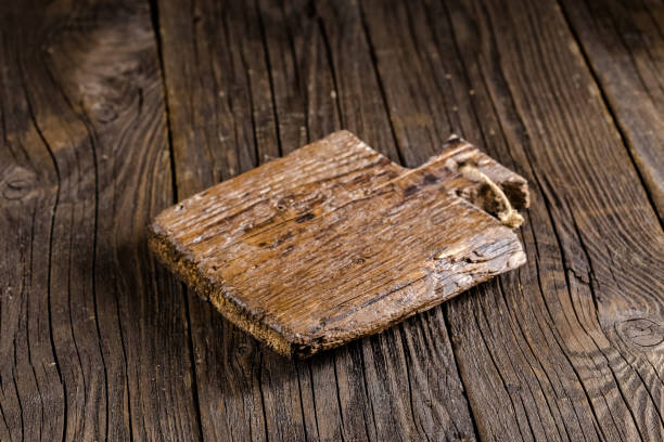 istock Russia, rustic old vintage wooden cutting board for the kitchen, with a groove structure, stripes, lies, stands on the table are cracks, black, brown, round square oval right angles sharp, rope 1148003721