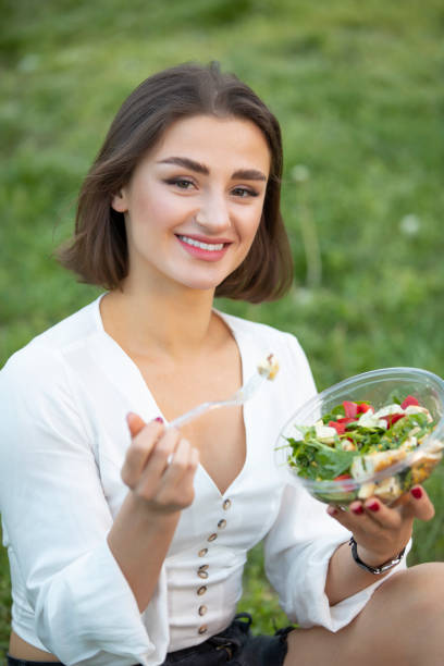istock Woman eating fresh salad at summer 1148003769