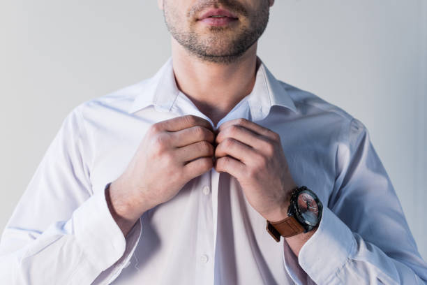istock partial view of confident handsome man putting on white shirt 1148004766