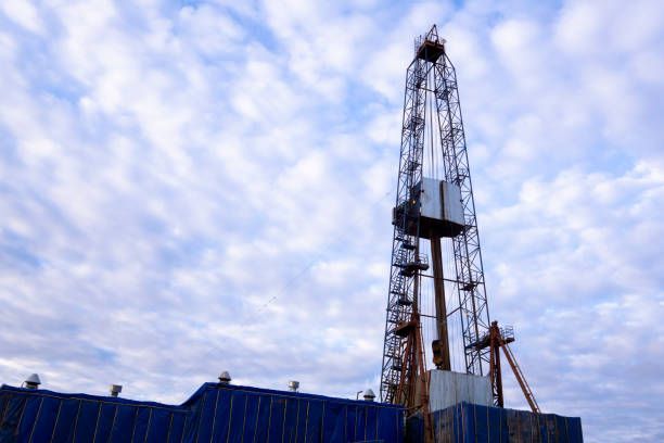istock Oil and Gas Drilling Rig onshore dessert with dramatic cloudscape. Oil drilling rig operation on the oil platform in oil and gas industry. 1148005105