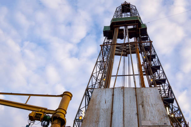 istock Oil and Gas Drilling Rig onshore dessert with dramatic cloudscape. Oil drilling rig operation on the oil platform in oil and gas industry. 1148005109